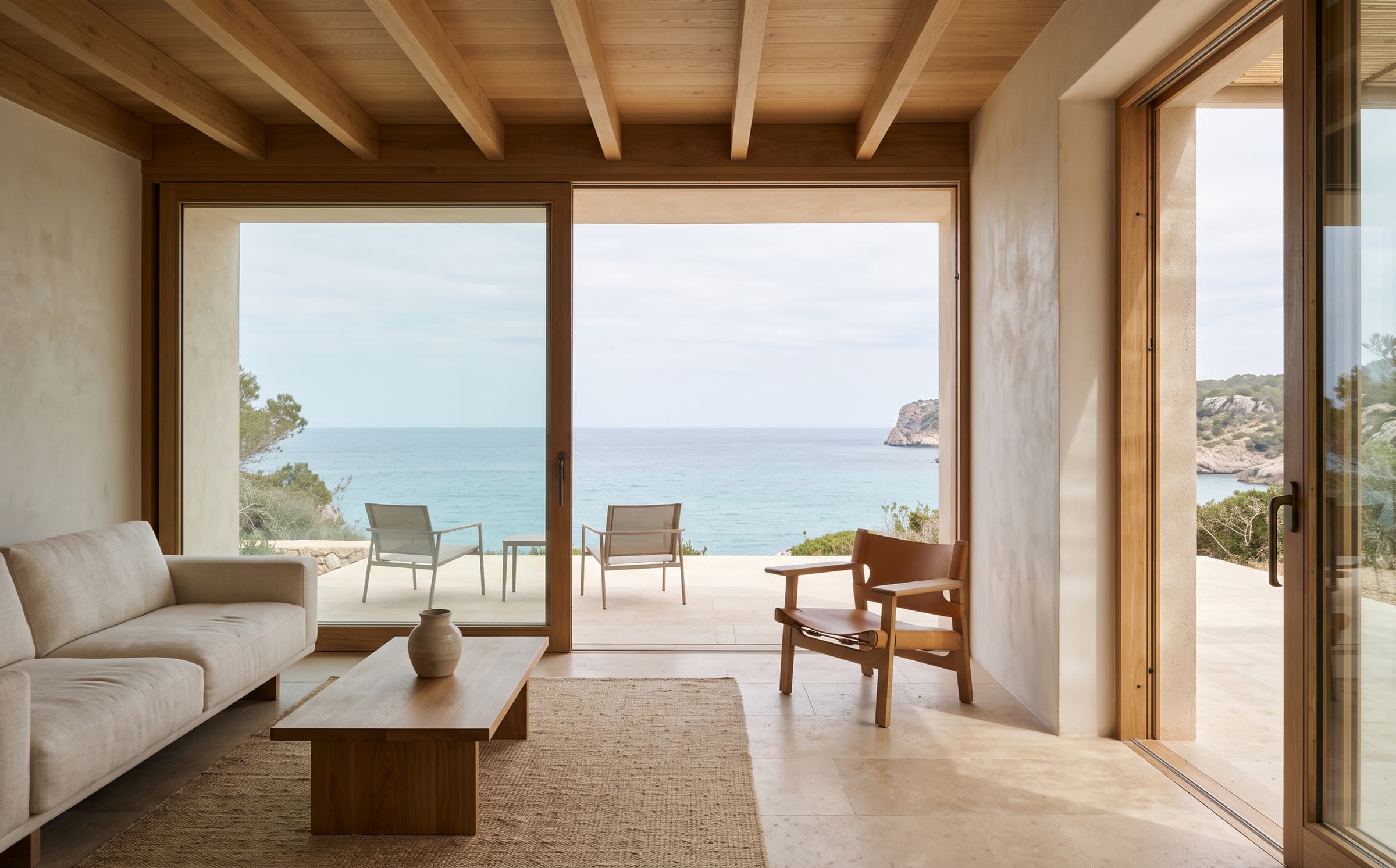 A warm living space at Marea House opening toward the sea